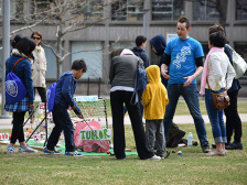 group of young people putt through a cancer-themed minigolf course